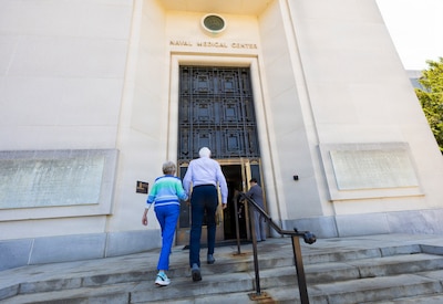 Former U.S. Navy pilot Mike Flannery and his wife, Carol, a former U.S. Navy nurse, enter Walter Reed National Military Medical Center, May 18, 2026, in Bethesda, Maryland, for the first time in more than five decades. The couple met at the hospital in 1969 and returned this month as part of a trip to Washington, D.C. (DOW photo by Ricardo J. Reyes)