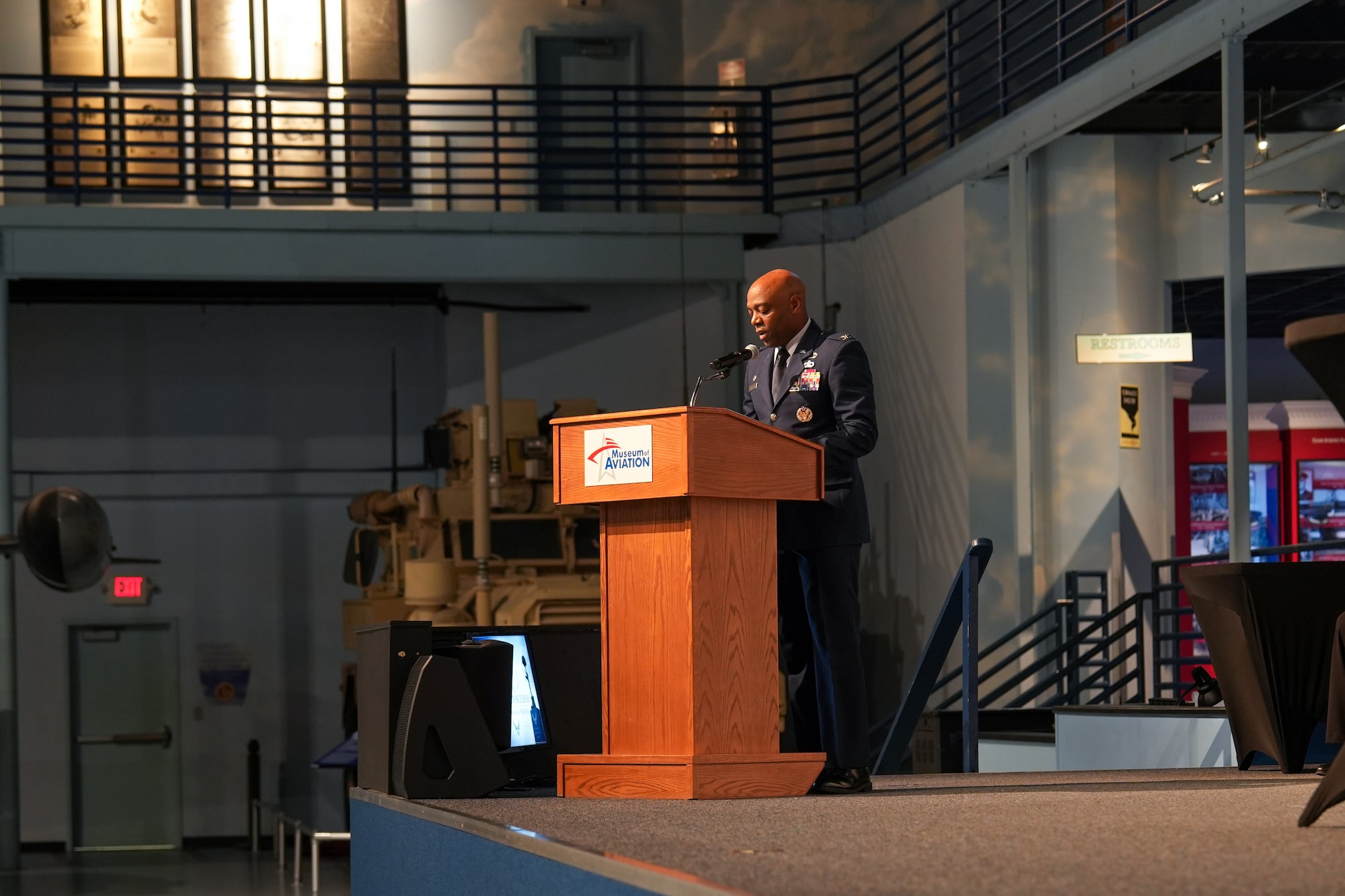 Man in military uniform speaks at a podium