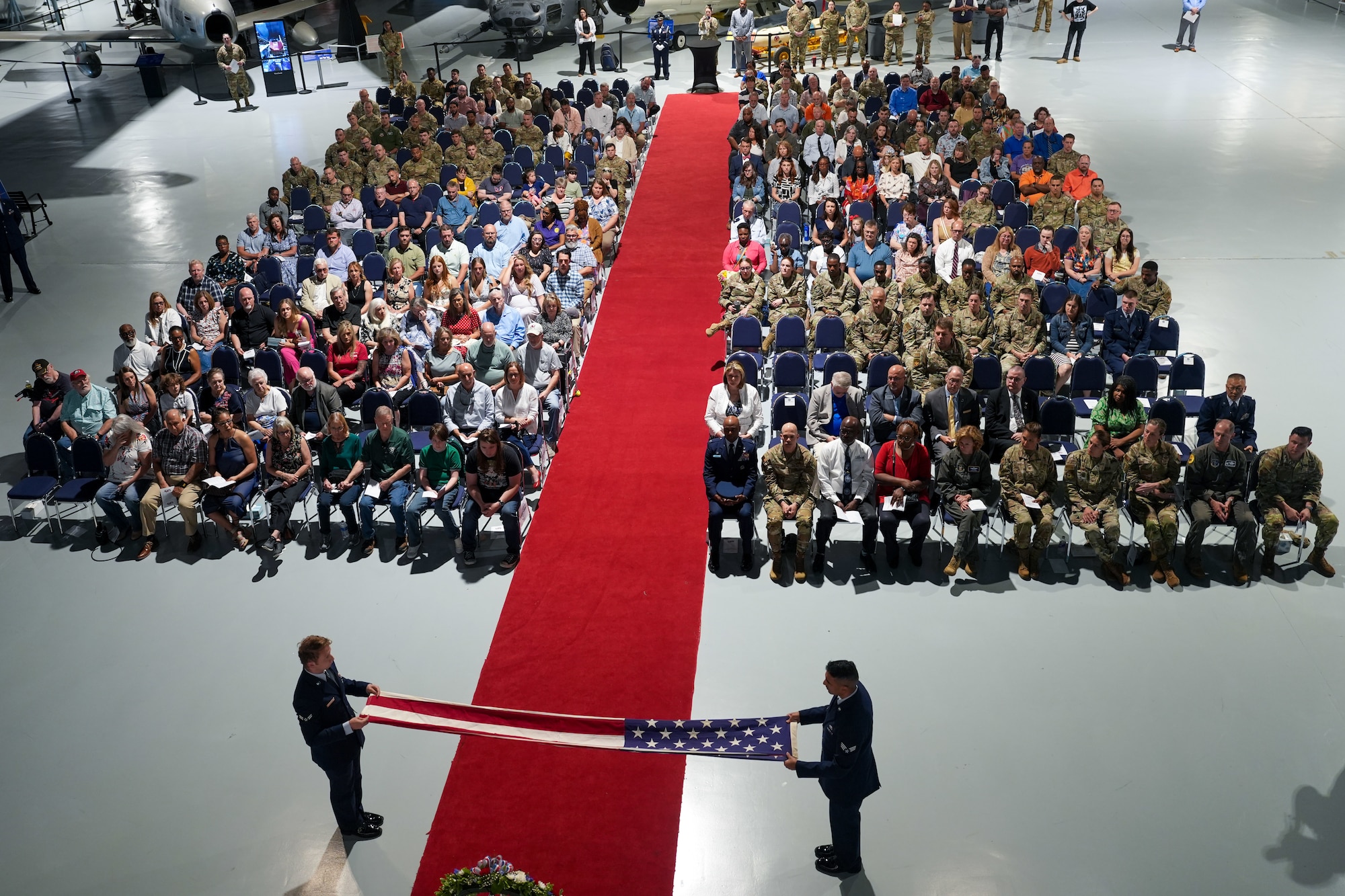 Two military honor guard members fold the American flag
