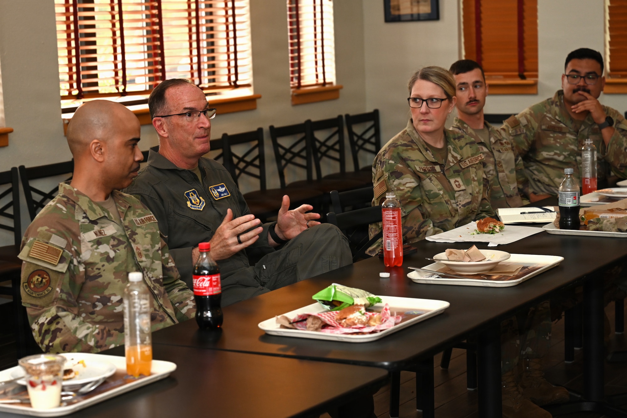 Airmen speak together during lunch