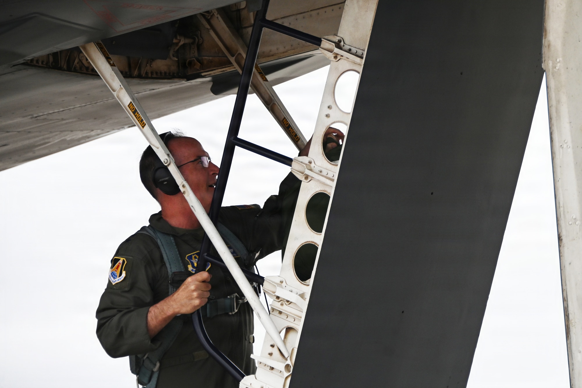 Airman climbs ladder into a B-1B Lancer