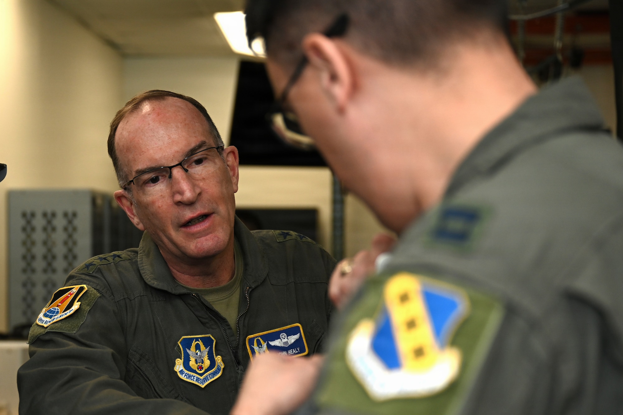 Airmen have a conversation in flight suits