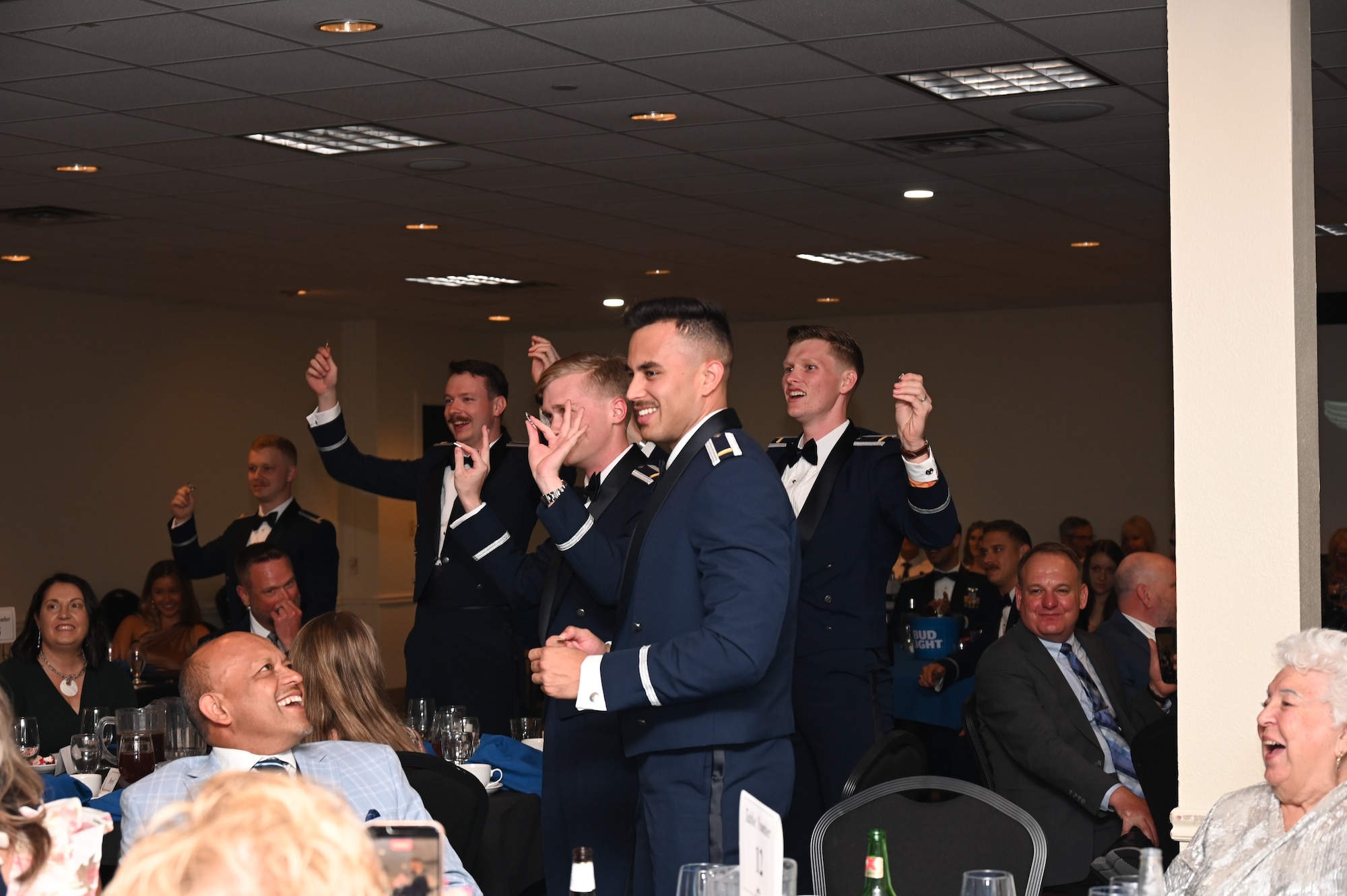 U.S. Air Force Airmen from graduating Class 26-11 break their wings at Laughlin Air Force Base, Texas, May 21, 2026. The breaking of silver wings is a tradition dating back to the U.S. Army Air Corps where a pilot's first wings are not to be worn but broken and given to a loved one. (U.S. Air Force photo by Airman 1st Class Kylie Rabb)