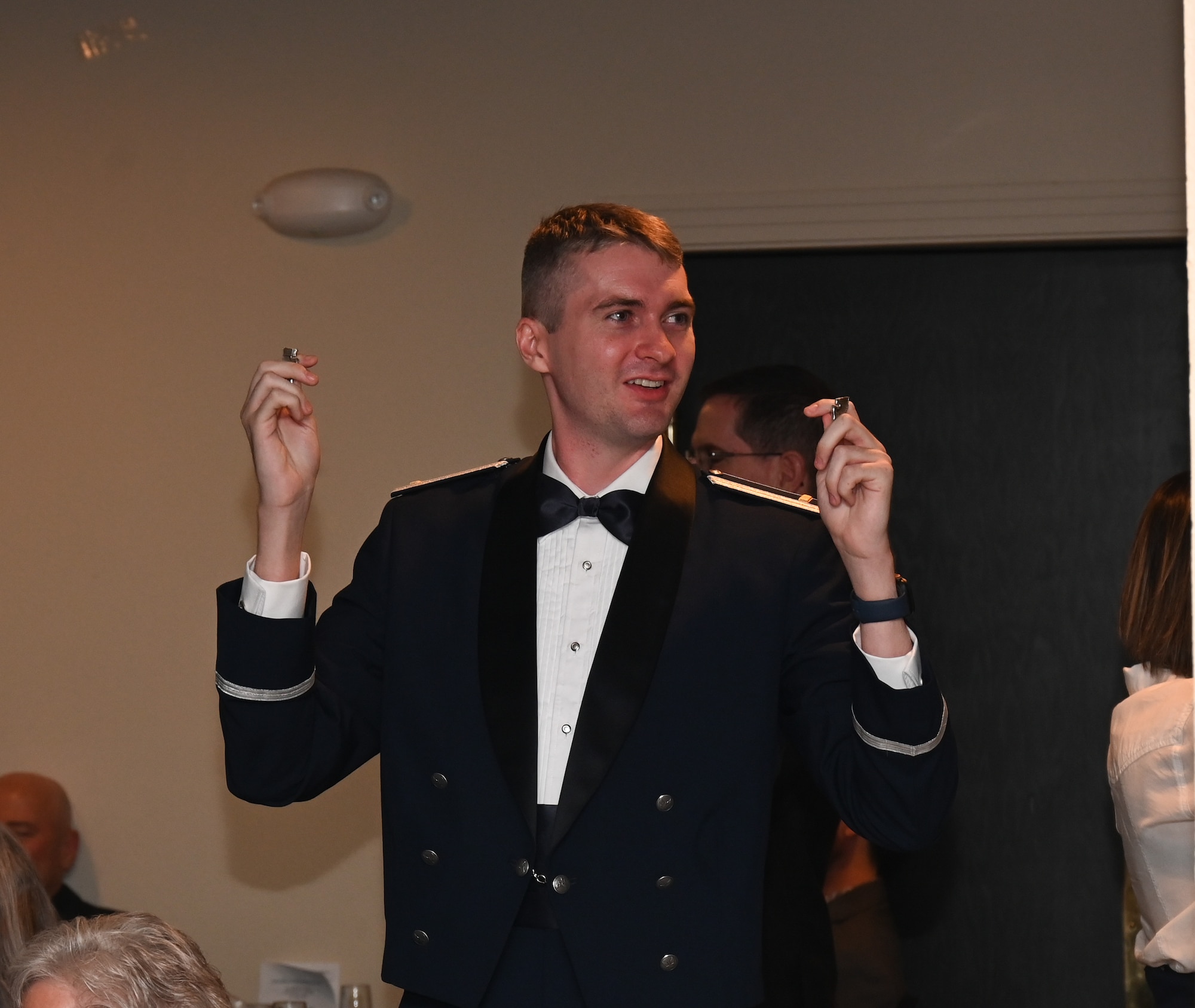 U.S. Air Force Airmen from graduating Class 26-11 break their wings at Laughlin Air Force Base, Texas, May 21, 2026. The breaking of silver wings is a tradition dating back to the U.S. Army Air Corps where a pilot's first wings are not to be worn but broken and given to a loved one. (U.S. Air Force photo by Airman 1st Class Kylie Rabb)