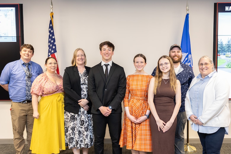 A group of students and mentors posing for a photo.