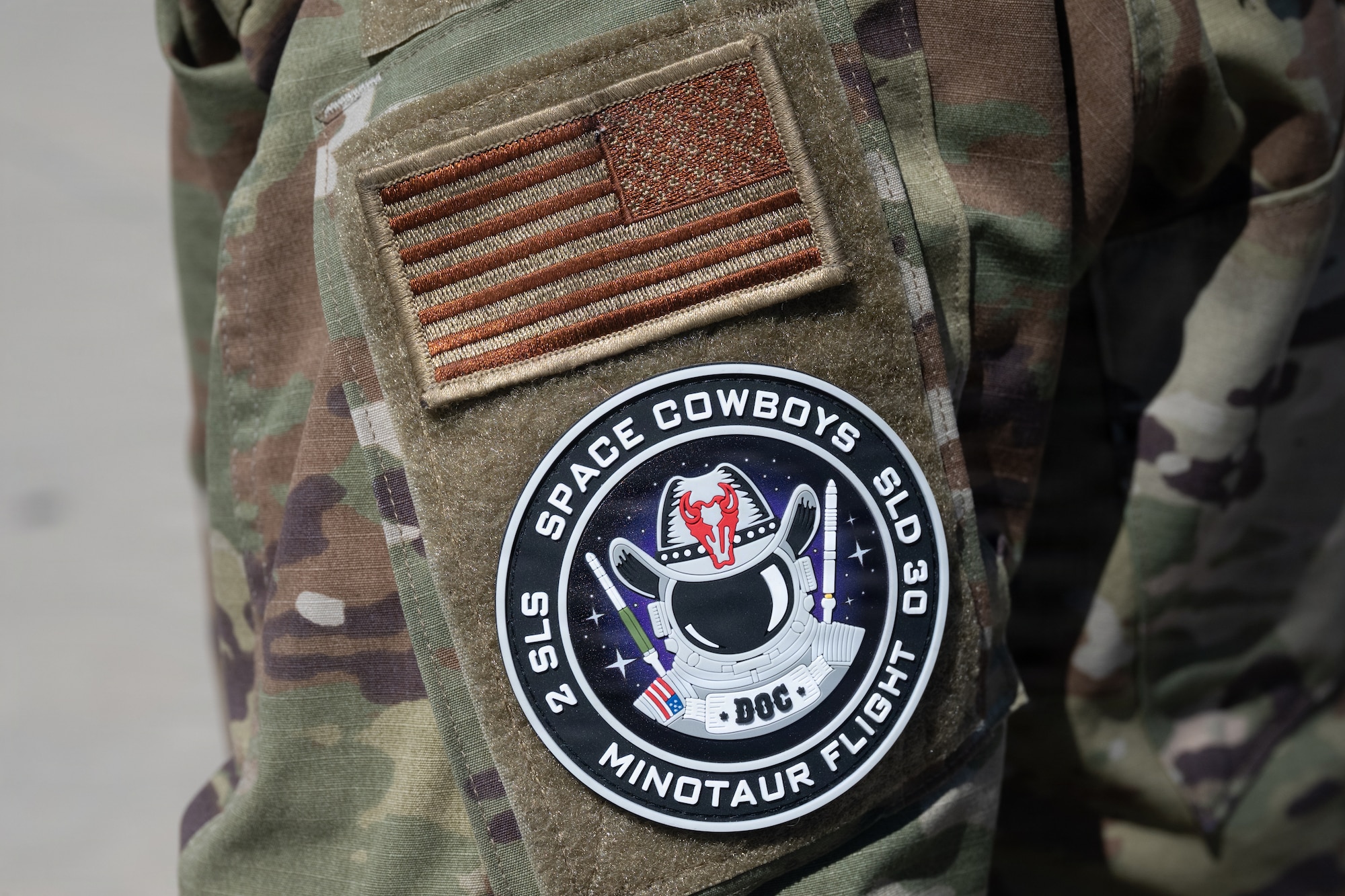 Pictured is an American flag and Space Cowboys Flight patch on a uniform.