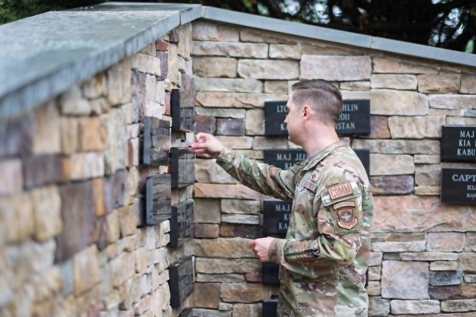 A U.S. Air Force Airman places a coin at the Air Advisor Memorial during the Air Advisor Memorial Foundation’s 14th Annual Remembrance Ceremony at Joint Base McGuire-Dix-Lakehurst, N.J., May 21, 2026.