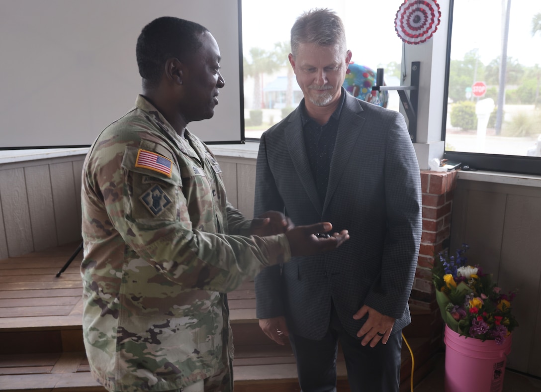 Col handing a man a coin.