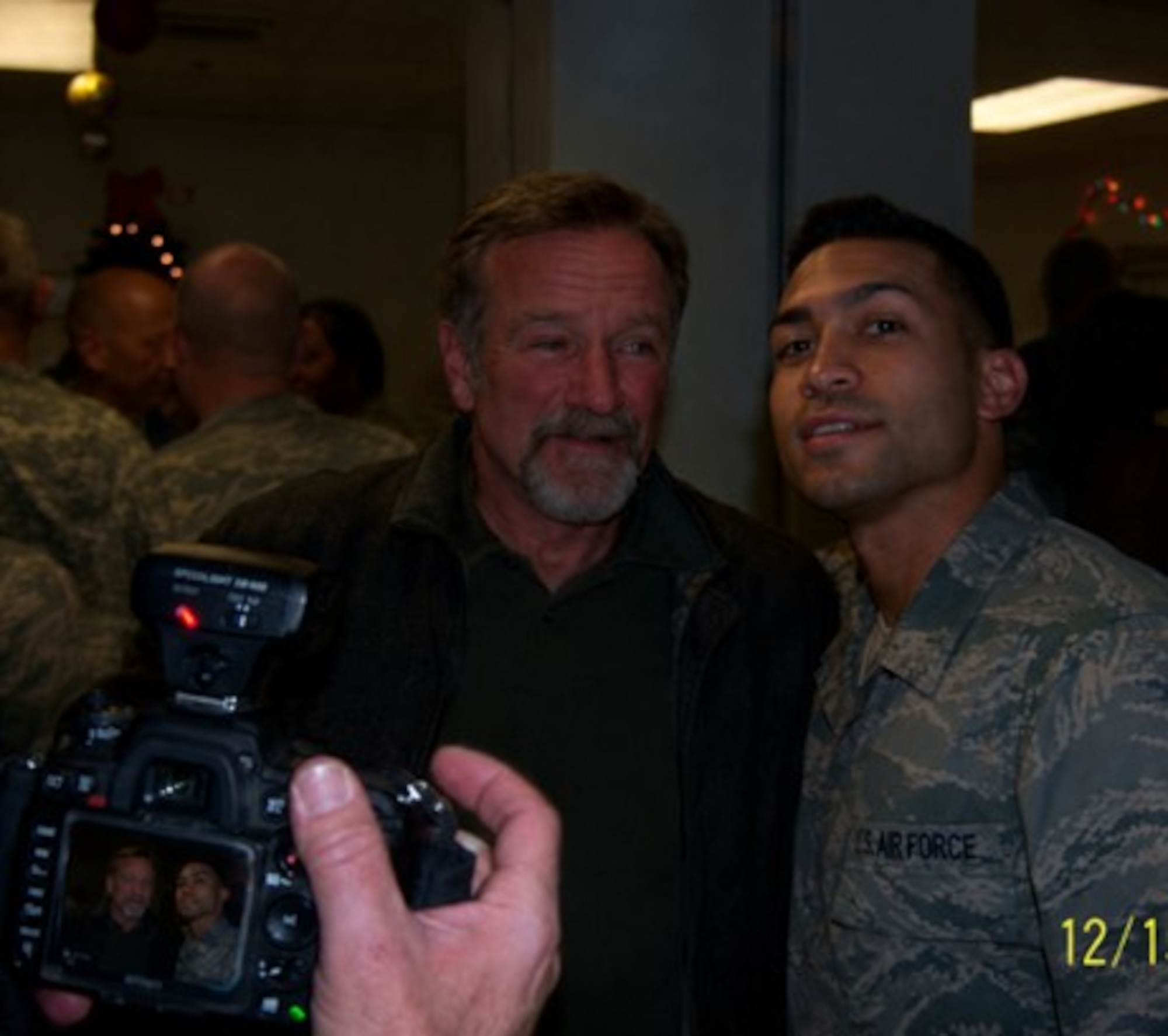 Robin Williams, left, poses for a photo with Staff Sgt. Joseph Carrillo, diet therapy specialist, right, at Bagram Air Base, Afghanistan, December 2010. Carrillo was excited for the opportunity to meet Williams as he admired the advocation work Williams did for mental health awareness. (Courtesy photo)