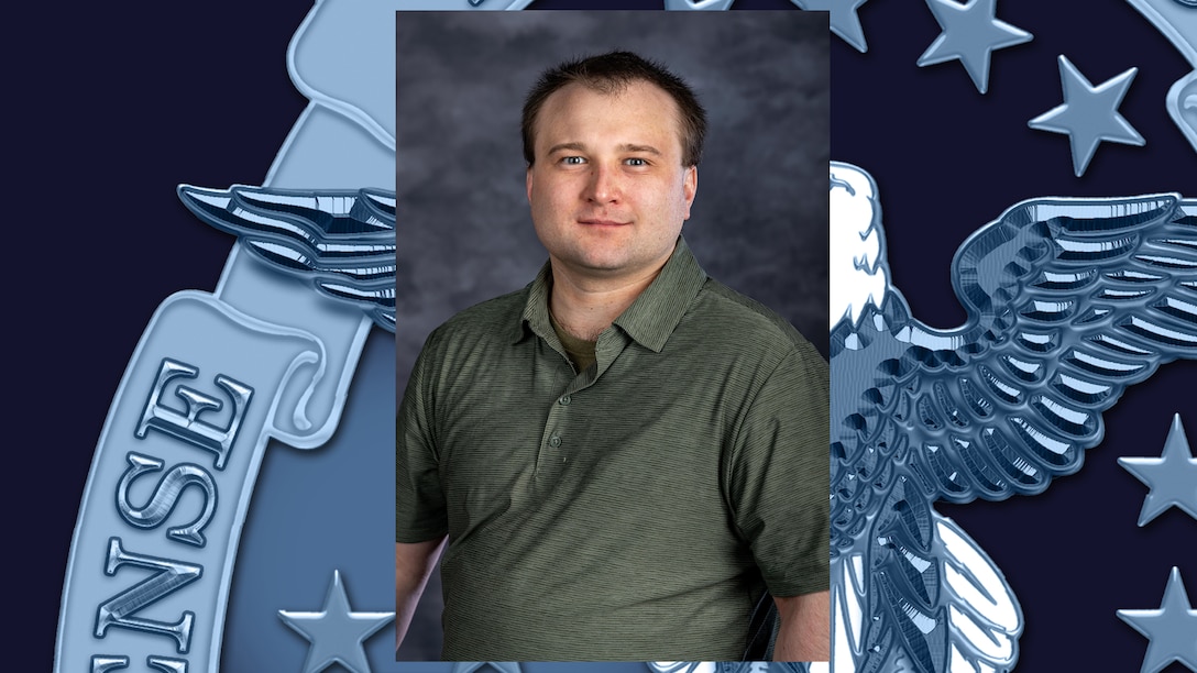 Headshot of man in green polo shirt