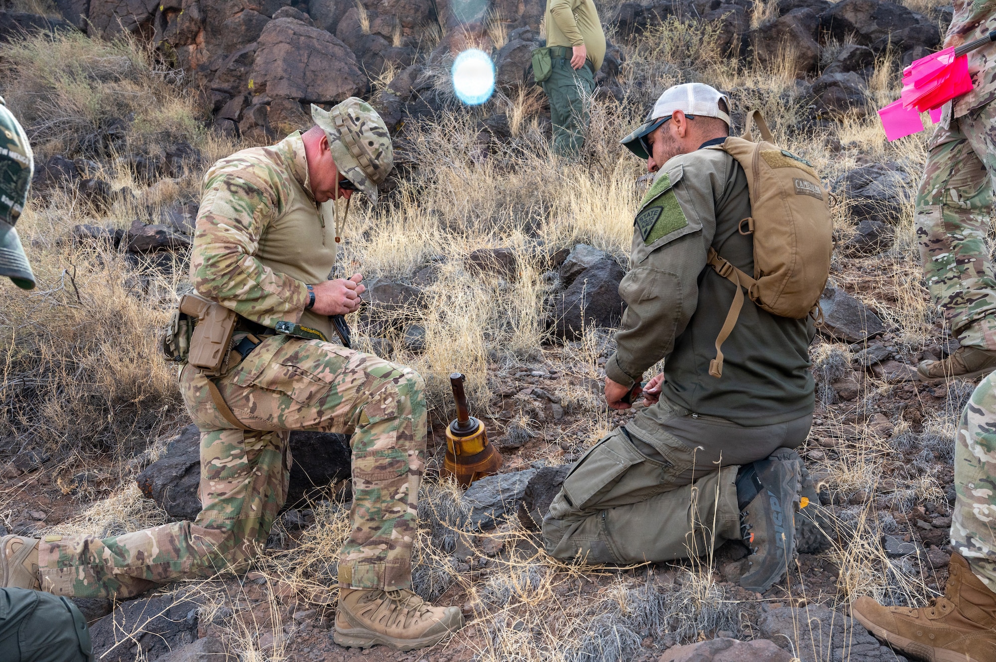 A U.S. Air Force explosive ordnance disposal technician assigned to the 377th Explosive Ordinance Disposal team works alongside New Mexico State Police Explosive Ordnance Disposal personnel to prepare an unexploded World War II-era ordnance item for disposal at the Pueblo of Acoma, New Mexico, May 20, 2026. The joint response effort included coordination with environmental agencies, New Mexico Fish and Wildlife officials, and Pueblo of Acoma representatives to ensure safe disposal operations with minimal environmental impact. (U.S. Air Force photo by Senior Airman Donnell Schroeter)