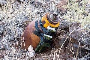 An unexploded World War II-era ordnance item rests in place prior to disposal operations conducted by the 377th Explosive Ordnance Disposal team and New Mexico State Police Explosive Ordnance Disposal personnel at the Pueblo of Acoma, New Mexico, May 20, 2026. The joint team coordinated with environmental specialists, New Mexico Fish and Wildlife officials, and Pueblo of Acoma representatives to safely dispose of the ordnance while minimizing impacts to the surrounding ecosystem. (U.S. Air Force photo by Senior Airman Donnell Schroeter)