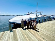 Members of the Mid-Atlantic Tech Bridge and 757 Defend and industry, making up the Defense Technology Accelerator cohort, pose in front of the Navy’s Stiletto demonstration platform along with Naval Surface Warfare Center Carderock Division Commanding Officer Capt. Chris Matassa on May 12 at the Norfolk, Va., downtown waterfront. Stiletto was on display for tours during the Department of the Navy Digital Warfighting Symposium.