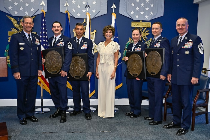 Air Force Chief of Staff Gen. Ken Wilsbach, left, Master Sgt. Steven Nelson, Chief Master Sgt. William Brakebill, Janine Sijan, Capt. Megan Langas, Maj. Joe Goliber and Chief Master Sgt. of the Air Force David Wolfe pose during a ceremony at the Pentagon in Arlington, Va., May 26, 2026. Nelson, Brakebill, Langas and Goliber were presented the Lance P. Sijan Award for leadership. (U.S. Air Force photo by Eric Dietrich)