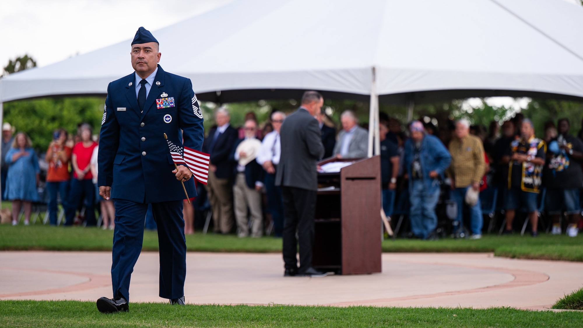 U.S. Air Force Chief Master Sgt. Dominik Gutierrez, 9th Bomber Generation Squadron senior enlisted leader, carries a flag for a final roll call during a Memorial Day ceremony at the Texas State Veterans Cemetery at Abilene, Texas, May 25, 2026. The Dyess Chiefs' Group and the cemetery hosted the observance, drawing hundreds of local residents, veterans and military families to honor those who made the ultimate sacrifice. (U.S. Air Force photo by Senior Airman Jade M. Caldwell)