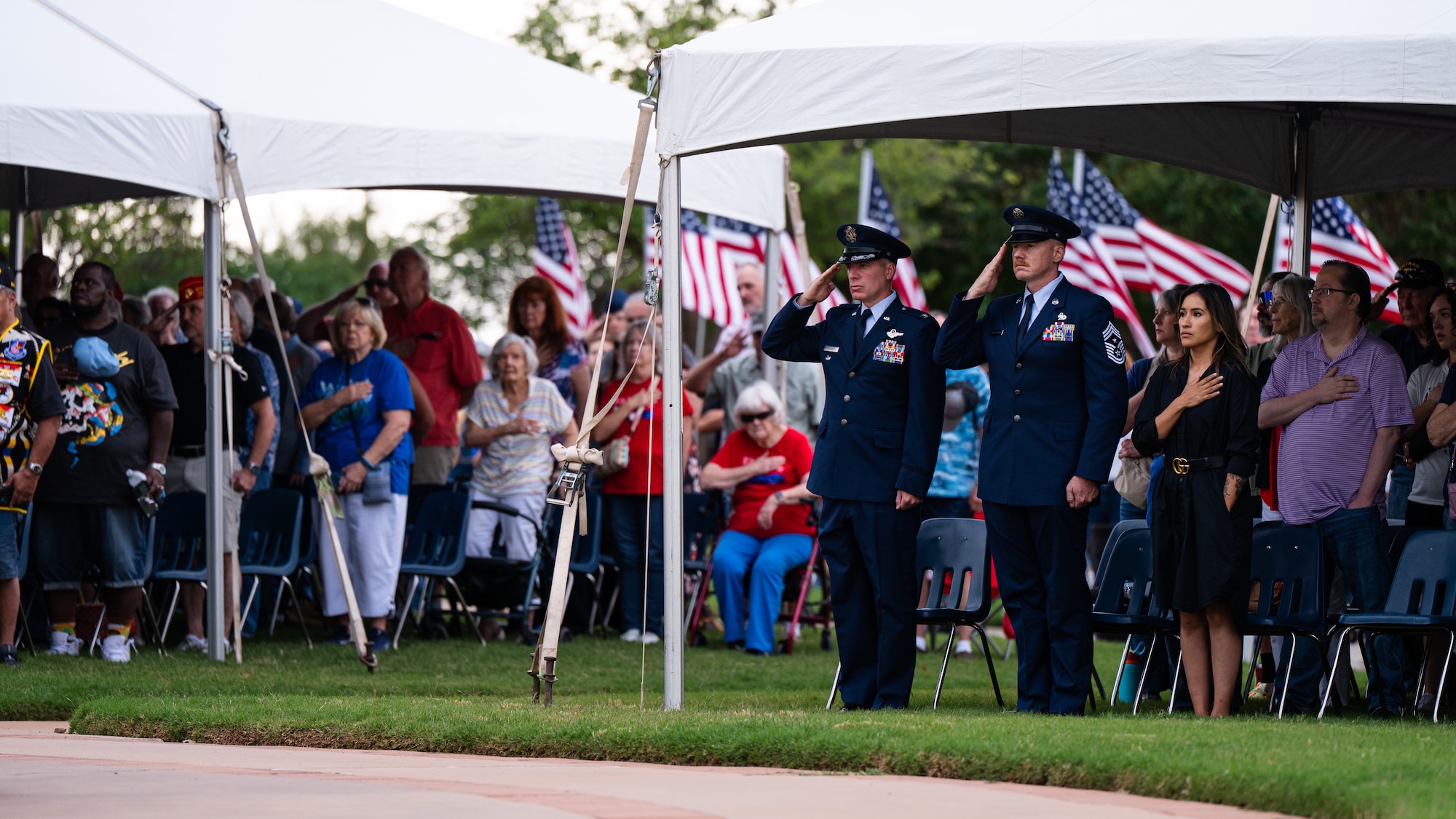 U.S. Air Force Col. Ryan Stallsworth, 7th Bomb Wing deputy commander, left, and Chief Master Sgt. Benjamin McCullough, 7th BW command chief, salute during the playing of taps at a Memorial Day ceremony at the Texas State Veterans Cemetery at Abilene, Texas, May 25, 2026. The traditional military bugle call honored fallen service members and marked a final farewell to those who made the ultimate sacrifice in defense of the nation. (U.S. Air Force photo by Senior Airman Jade M. Caldwell)