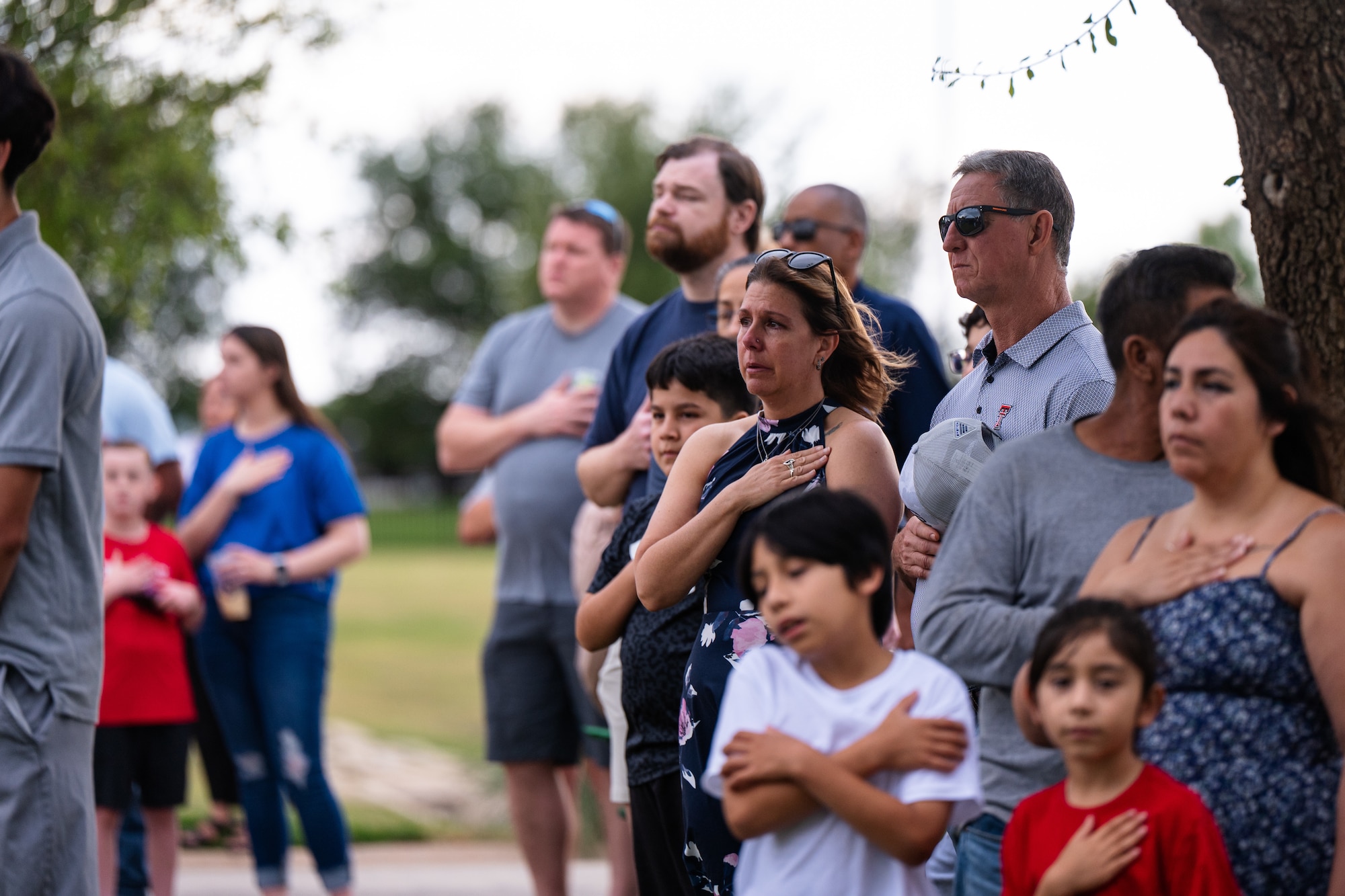 Event attendees place their hands over their hearts during the playing of taps at a Memorial Day ceremony at the Texas State Veterans Cemetery at Abilene, Texas, May 25, 2026. The Dyess Chiefs' Group and the cemetery hosted the observance, drawing hundreds of local residents, veterans and military families to honor those who made the ultimate sacrifice. (U.S. Air Force photo by Senior Airman Jade M. Caldwell)