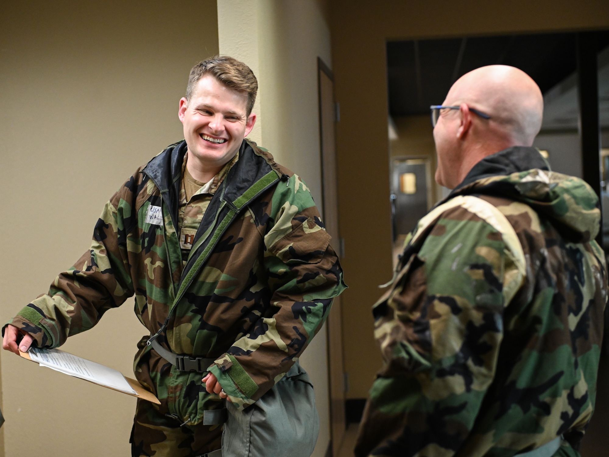 U.S. Air Force Capt. Drew Wacker, 210th Engineering Installation Squadron, speaks with a fellow Airman during chemical, biological, radiological and nuclear (CBRN) training at Camp Gruber Training Center, Oklahoma, April 27, 2026.