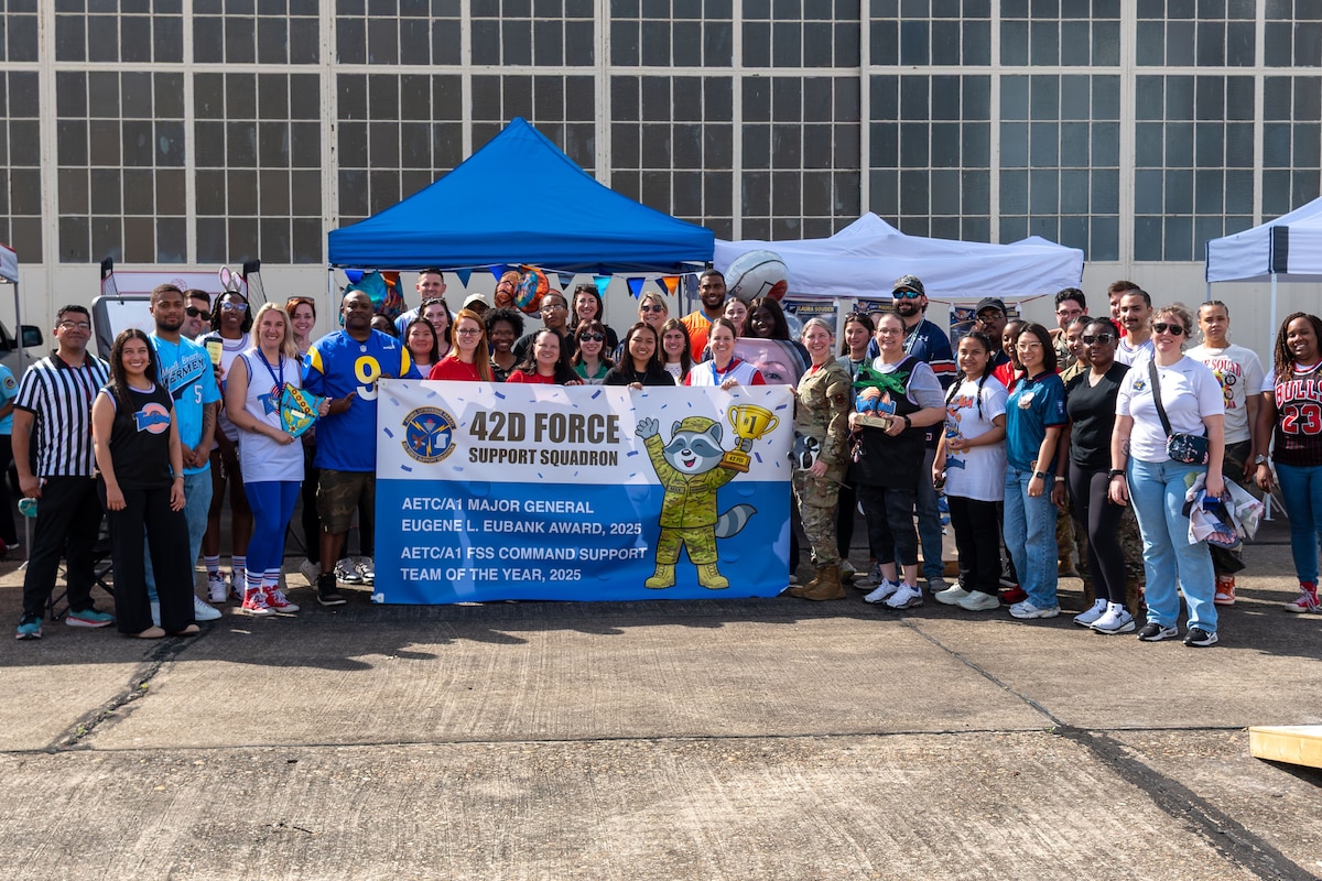 Members of the 42d Force Support Squadron hold a recognition banner at Maxwell Air Force Base, March 6, 2026. The unit was recognized as winning the Maj. Gen Eugene L. Eubank Award for 2025 for Air Education and Training Command