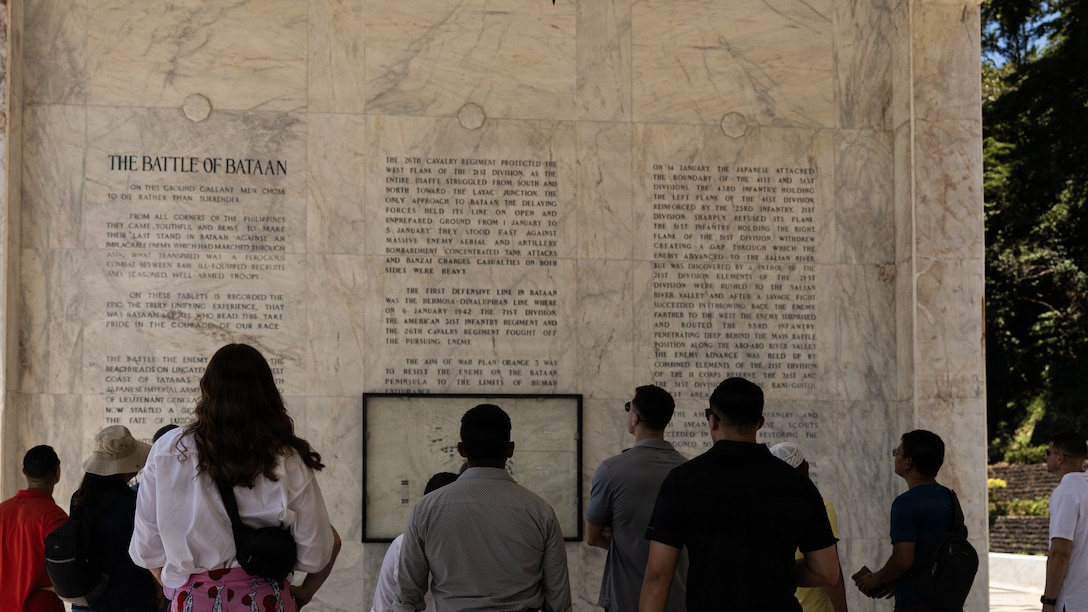 U.S. Marines with Marine Rotational Force – Southeast Asia, I Marine Expeditionary Force, read an inscription detailing the Battle of Bataan during a staff ride in honor of Memorial Day at Mount Samat National Shrine of Valor, Bataan, Philippines, May 23, 2026. MRF-SEA serves as I MEF’s forward command element, supporting Task Force - Philippines and integrating with the Armed Forces of the Philippines to strengthen interoperability and improve combined readiness. (U.S. Marine Corps photo by Cpl. Ryan Ramsammy)