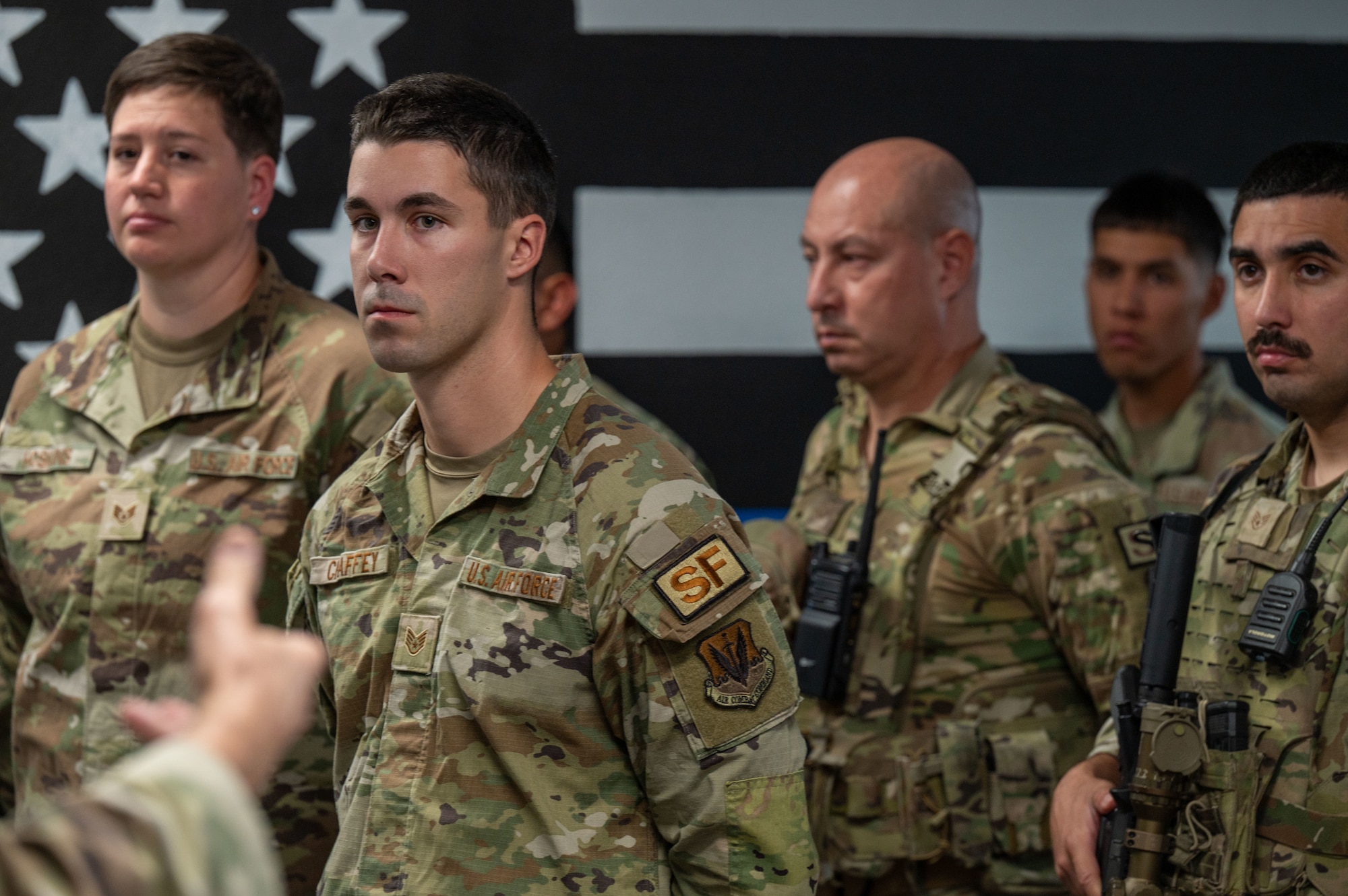 U.S. Air Force Airmen assigned to the 355th Security Forces Squadron listen to closing remarks from U.S. Air Force Col. Christopher Callus, Air Forces Southern director of international engagements and plans, requirements, programs and assessments,  during the Final Guard Mount ceremony at Davis-Monthan Air Force Base, Arizona, May 21, 2026. The ceremony marked the end of Police Week, a weeklong observance that pays tribute to the Security Forces members and law enforcement personnel. (U.S. Air Force photo by Airman 1st Class Jaden Kidd)