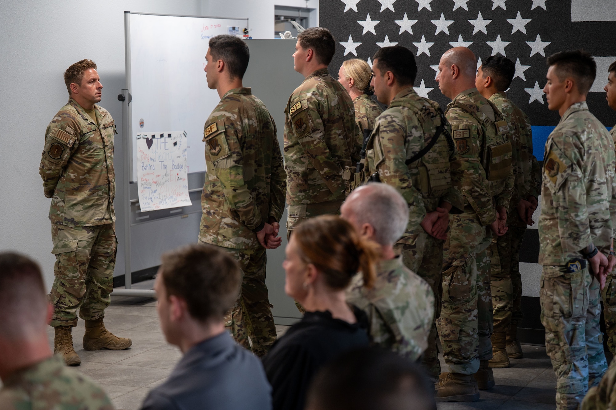 U.S. Air Force Master Sgt. Joshua Reid, 355th Security Forces Squadron flight chief, commands the Final Guard Mount ceremony at Davis-Monthan Air Force Base, Arizona, May 21, 2026. The ceremony mirrored the daily guard mount, during which defenders are armed and briefed before their shifts, while also honoring fallen defenders. (U.S. Air Force photo by Airman 1st Class Jaden Kidd)