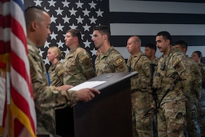 U.S. Air Force Tech. Sgt. Marc Rouisse Quijano, 355th Security Forces Squadron flight sergeant, reads the names of fallen defenders during the Final Guard Mount ceremony at Davis-Monthan Air Force Base, Arizona, May 21, 2026. The ceremony honored defenders who made the ultimate sacrifice. (U.S. Air Force photo by Airman 1st Class Jaden Kidd)