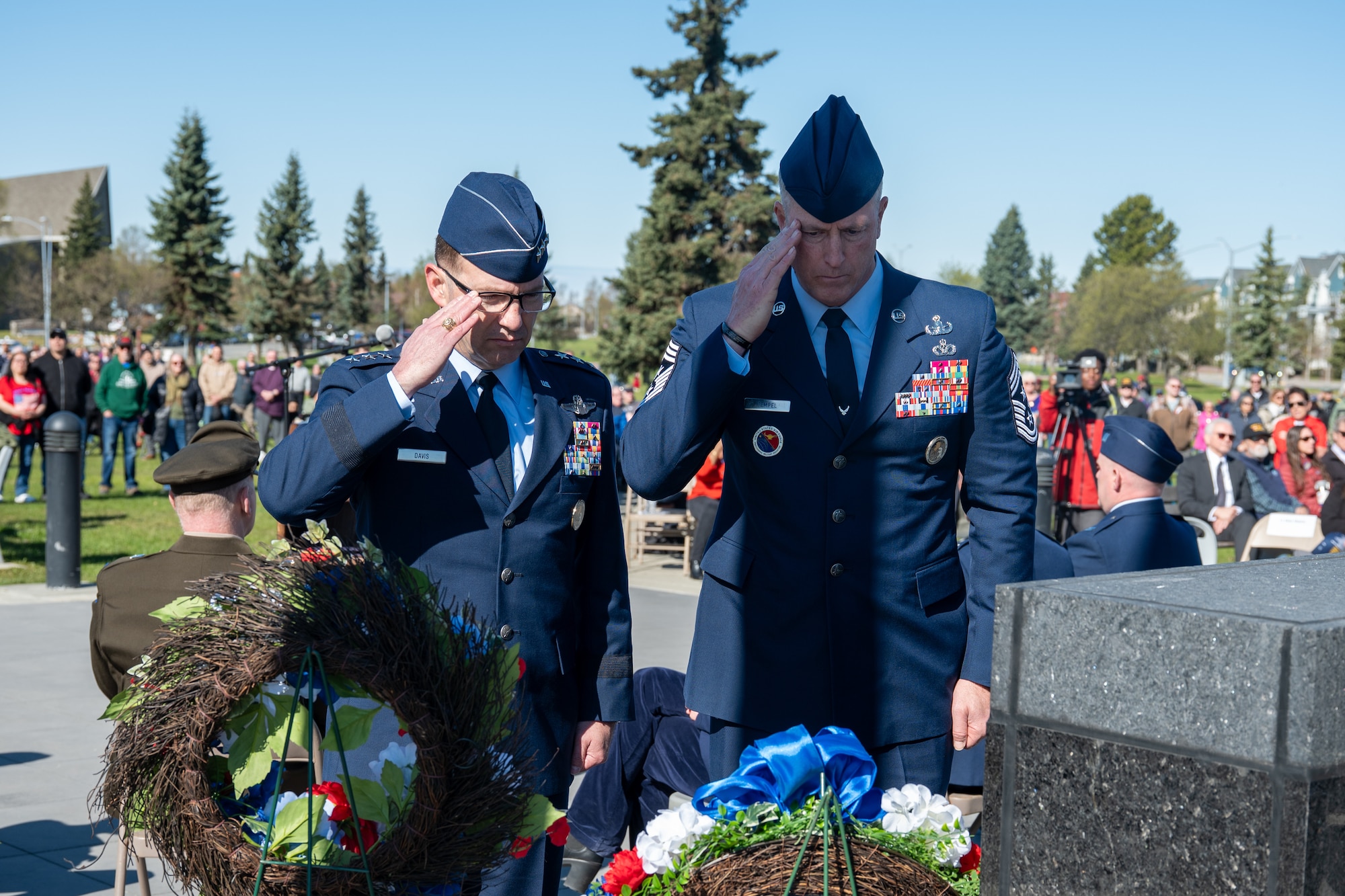 U.S. Air Force Lt. Gen. Robert Davis, 11th Air Force commander, and Chief Master Sgt. Heath Tempel, 11th Air Force command chief, salute a ceremonial wreath during the Anchorage Remembers Memorial Day Ceremony at the Delaney Park Strip Veterans Memorial in Anchorage, Alaska, May 25, 2026. Local civic and military leaders gathered to place wreaths at the base of the memorial statue. (U.S. Air Force photo by Airman 1st Class Theodore Gowdy)
