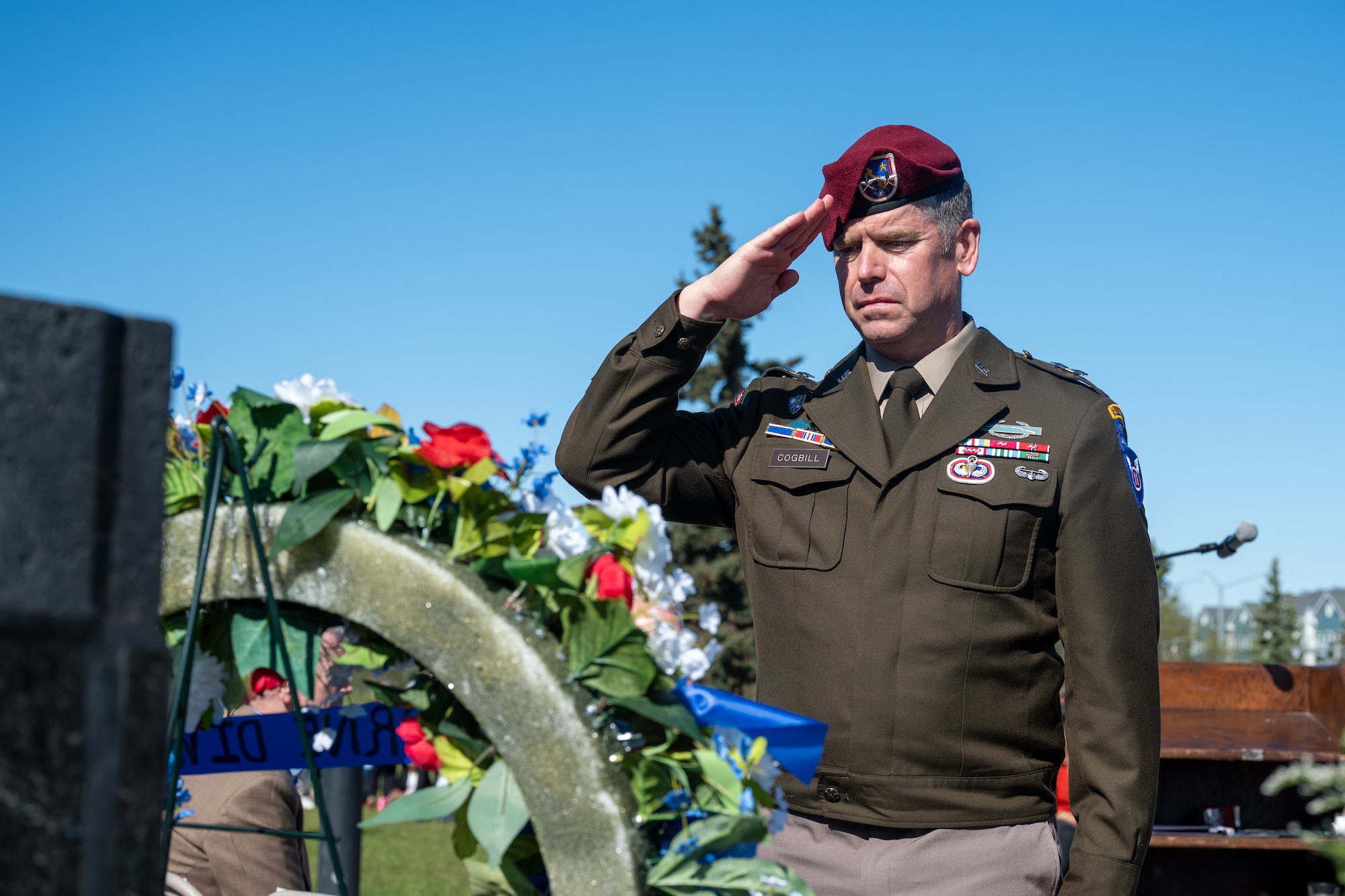 U.S. Army Maj. Gen. John Cogbill, 11th Airborne Division commander, salutes a ceremonial wreath during the Anchorage Remembers Memorial Day ceremony at the Delaney Park Strip Veterans Memorial in Anchorage, Alaska, May 25, 2026. The outdoor observance drew hundreds of local residents, veterans and military families to the downtown park strip. (U.S. Air Force photo by Airman 1st Class Theodore Gowdy)