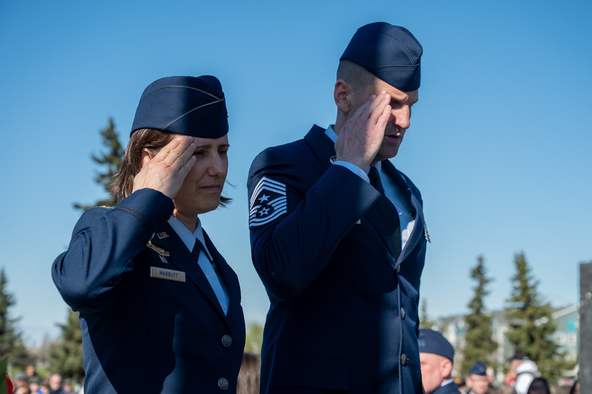 U.S. Air Force Col. Lisa Mabbutt, 673d Air Base Wing and Joint Base Elmendorf-Richardson installation commander, and Chief Master Sgt. Daniel Sylvester, 673d ABW command chief, salute a ceremonial wreath during the Anchorage Remembers Memorial Day Ceremony at the Delaney Park Strip Veterans Memorial in Anchorage, Alaska, May 25, 2026. The presentation of wreaths opened the official Municipality of Anchorage Memorial Day observance. (U.S. Air Force photo by Airman 1st Class Theodore Gowdy)
