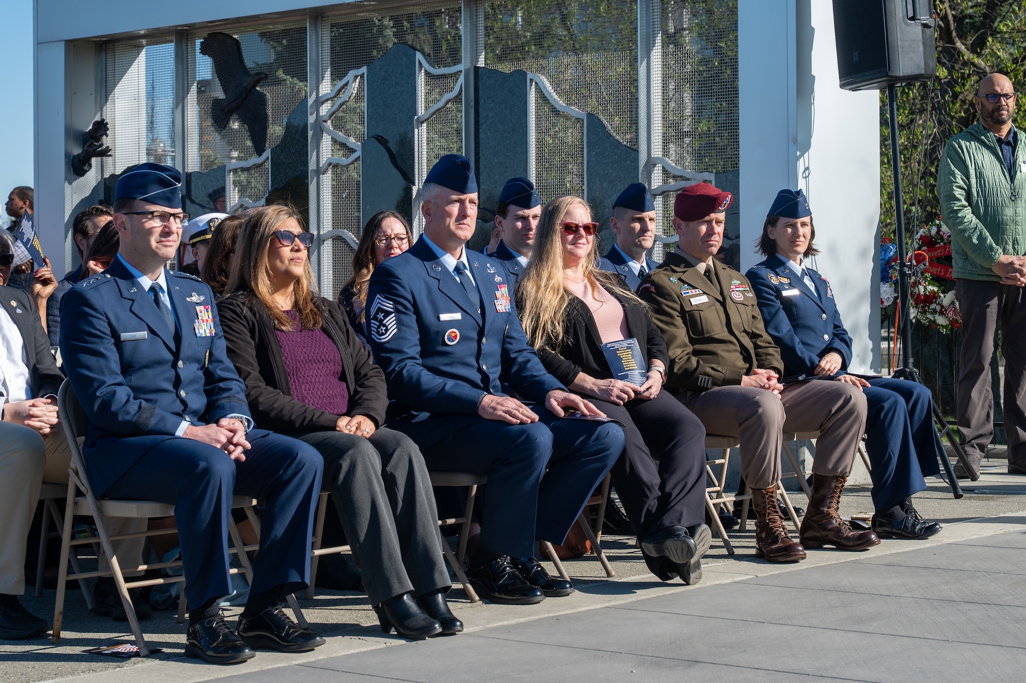 Senior military leadership from the 11th Air Force, 11th Airborne Division and 673d Air Base Wing, alongside their spouses, watch the guest speakers during the Anchorage Remembers Memorial Day Ceremony at the Delaney Park Strip Veterans Memorial in Anchorage, Alaska, May 25, 2026. The annual event honored U.S. military service members who died in the line of duty. (U.S. Air Force photo by Airman 1st Class Theodore Gowdy)
