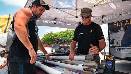 A Soldier explains Army equipment and capabilities to visitors at an Army display booth during the Hyundai Air & Sea Show at Miami Beach, Florida, May 24, 2026. The Memorial Day weekend event showcased military technology, interactive exhibits and service member engagement opportunities to educate the public about the missions and readiness of the U.S. Armed Forces.