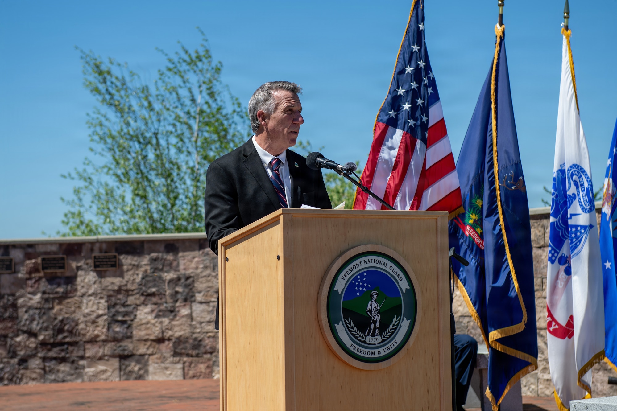 Photo of Vermont Gov. Phil Scott delivering remarks during a Memorial Day ceremony at Camp Johnson in Colchester, Vt., May 21, 2026.