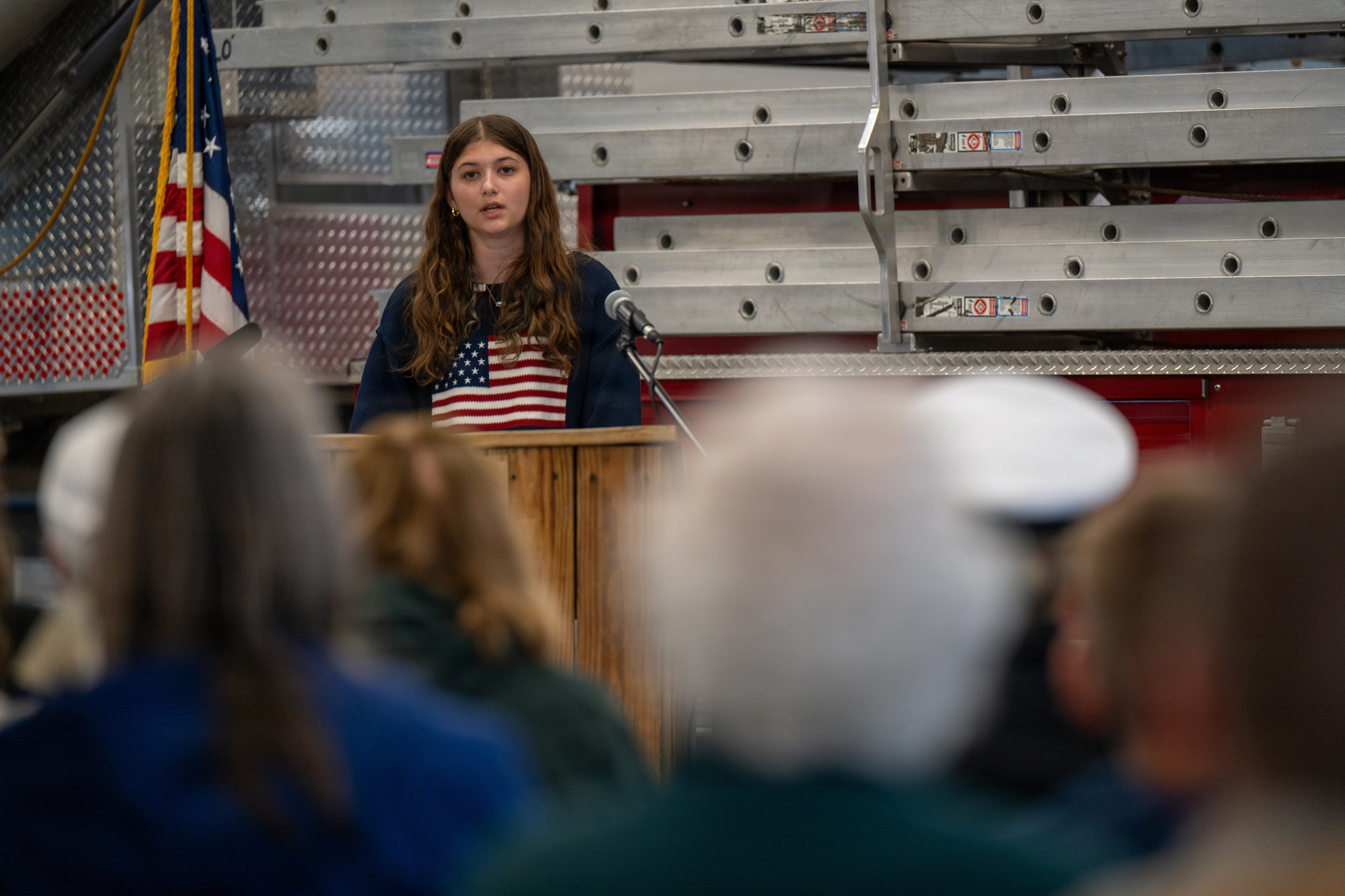 Photo of Brooke Adams, daughter of a currently deployed service member, delivering remarks during a Memorial Day ceremony in Milton, Vt., May 25, 2026.