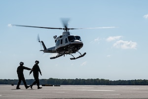 U.S. Marines assigned to Marine Aircraft Group 49 direct a New York Police Department Aviation Unit helicopter onto the flight line at Joint Base McGuire-Dix-Lakehurst, N.J., May 1, 2026. Local first responders and mission partners participated in the Mid-Atlantic Aviation Coordination Summit where they discussed how to effectively work together in the event of a large-scale disaster. (U.S. Air Force photo by Airman 1st Class Haeleigh Bayle)