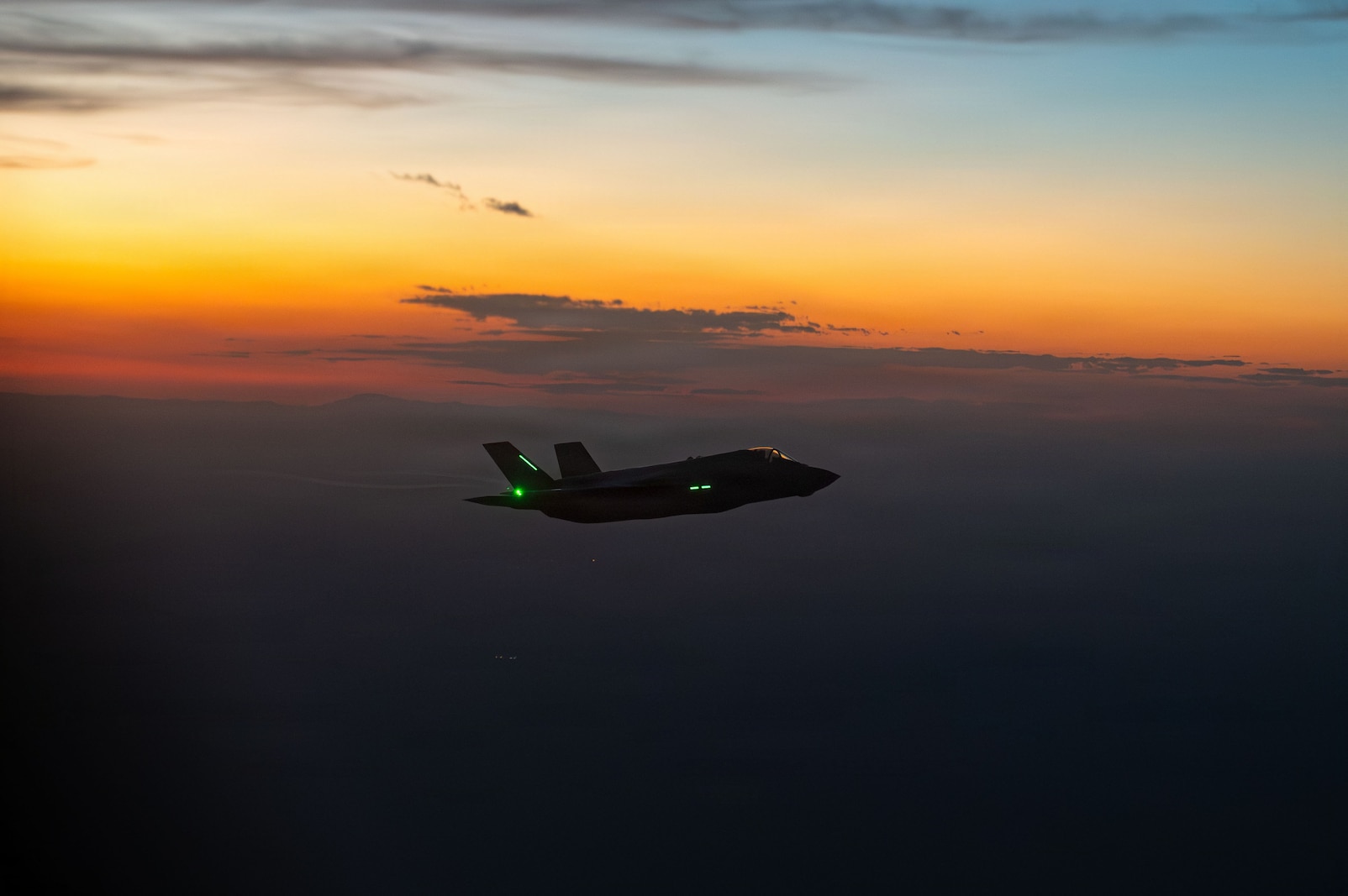 Photo of a U.S. Marine Corps F-35B Lightning II aircraft assigned to the Marine Operational Test & Evaluation Squadron 1, flies alongside a U.S. Air Force HC-130J Combat King II aircraft as part of exercise Mosaic Lightning 26-2 over southern Arizona, May 12, 2026.