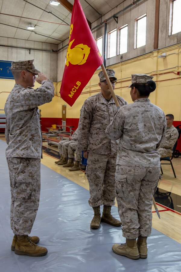 Marines, civilians and their families gathered for a change-of-command ceremony highlighting Capt. Nicholas May relinquishing command to Capt. Maria Hurtado, the new Headquarters Company commanding officer aboard Marine Corps Logistics Base, Barstow California May 26.