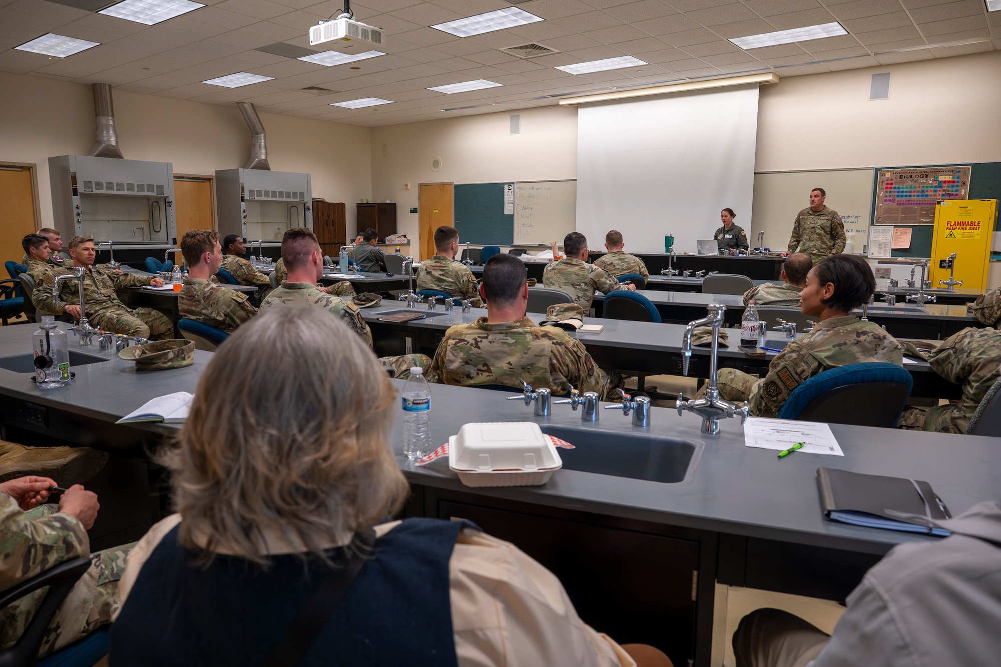 Military members talk during an air show meeting.