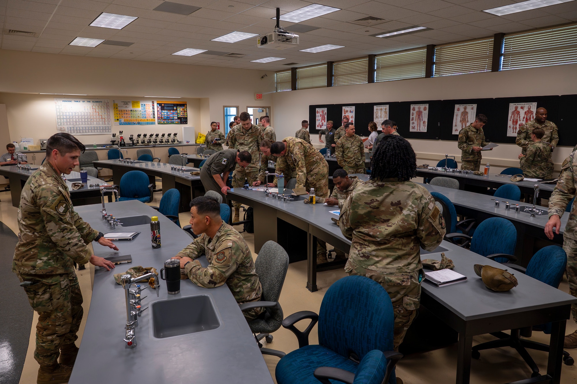 Military members talk during an air show meeting.