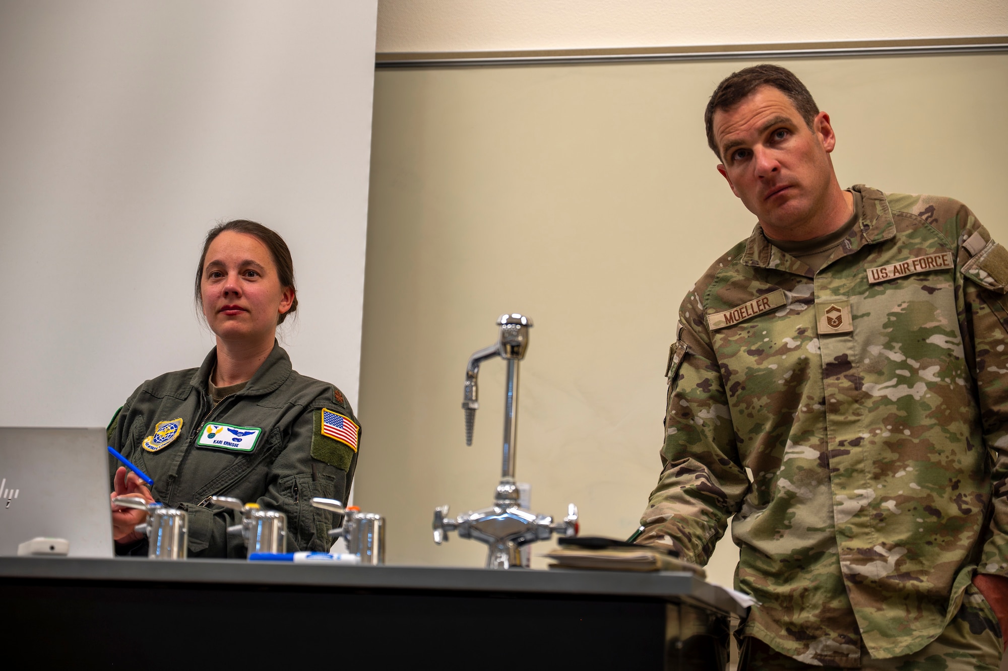 Military members talk during an airshow meeting
