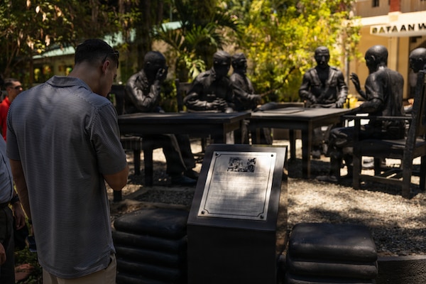 U.S. Marine Corps Capt. David Robinson, a space plans officer with Marine Rotational Force – Southeast Asia, I Marine Expeditionary Force, reads a plaque detailing the surrender of U.S. Army Forces in the Far East after the Battle of Bataan during a staff ride in honor of Memorial Day at the Bataan World War II Museum, Bataan, Philippines, May 23, 2026.