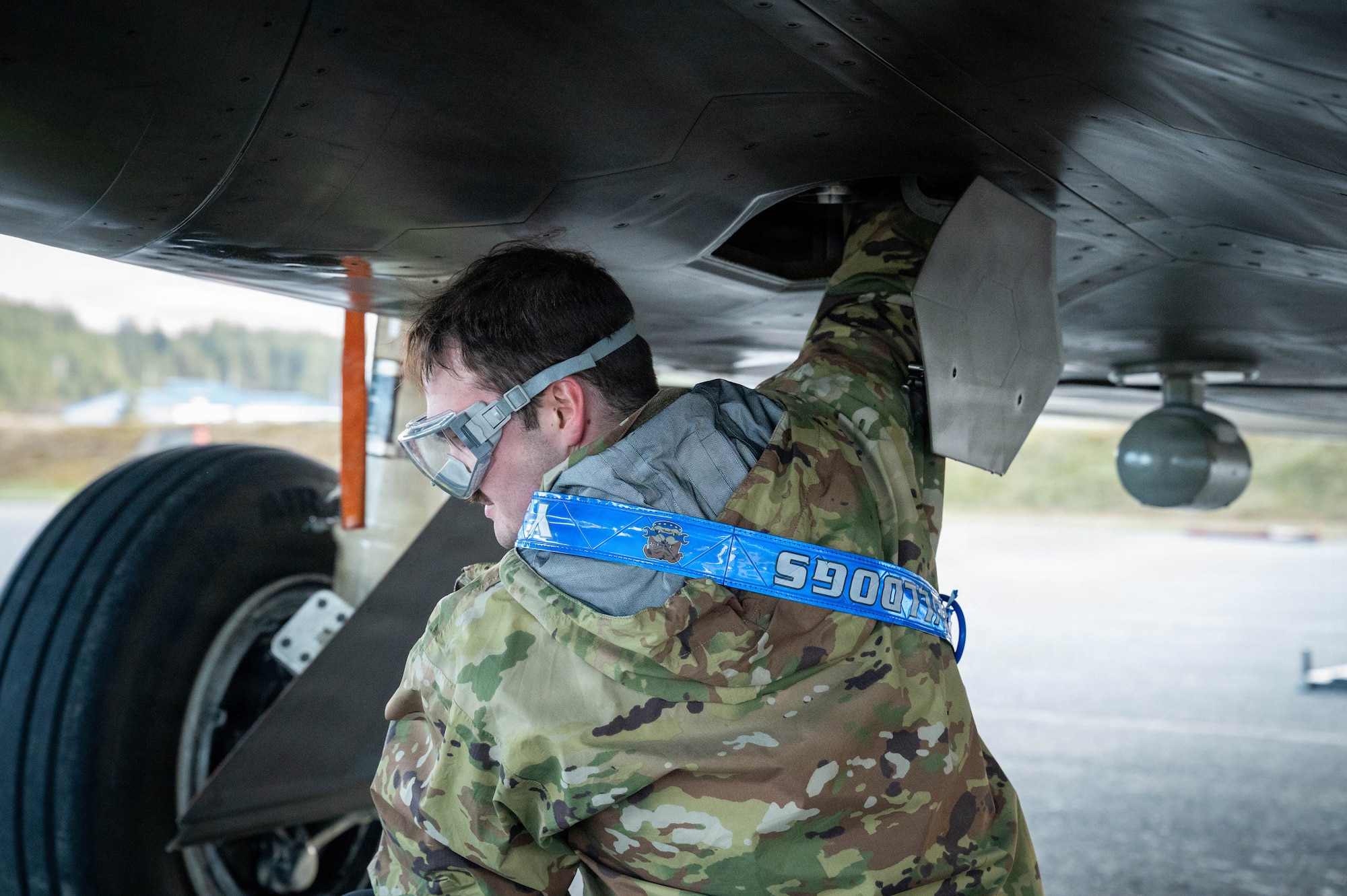A U.S. Air Force Dedicated Crew Chief assigned to the 3rd Air Expeditionary Wing conducts a post-flight check on the engine oil of an F-22 Raptor aircraft assigned to the 3rd Wing during exercise Tropic Tundra 26 at U.S. Coast Guard Air Station Kodiak, Alaska, May 11, 2026.