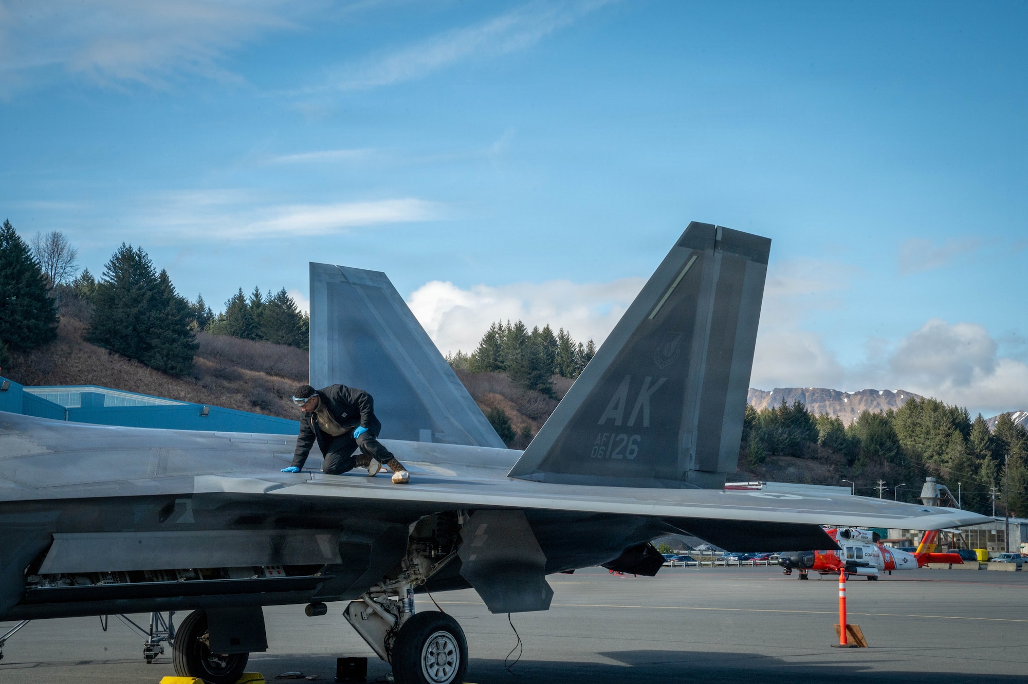 A U.S. Air Force Dedicated Crew Chief assigned to the 3rd Air Expeditionary Wing conducts a post-flight check on an F-22 Raptor aircraft assigned to the 3rd Wing during exercise Tropic Tundra 26 at U.S. Coast Guard Air Station Kodiak, Alaska, May 12, 2026.