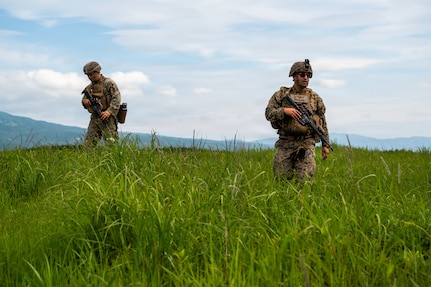 U.S. Marines with the 3rd Battalion, 12th Marine Regiment, 3rd Marine Division scout a location before parking a High Mobility Artillery Rocket System during a demonstration at the East Fuji Maneuver Area, Camp Fuji, Japan, May 20, 2026.