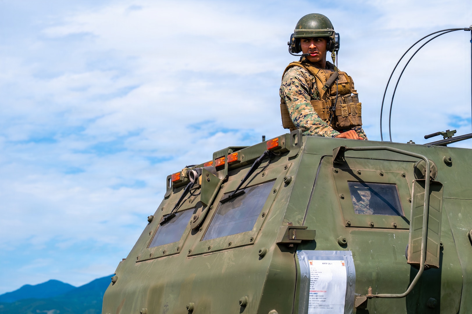U.S. Marine Corps Sgt. Kevin Alvarez, 3rd Battalion, 12th Marine Regiment HIMARS section chief, guides the driver of a High Mobility Artillery Rocket System during a training demonstration at the East Fuji Maneuver Area, Camp Fuji, Japan, May 20, 2026.