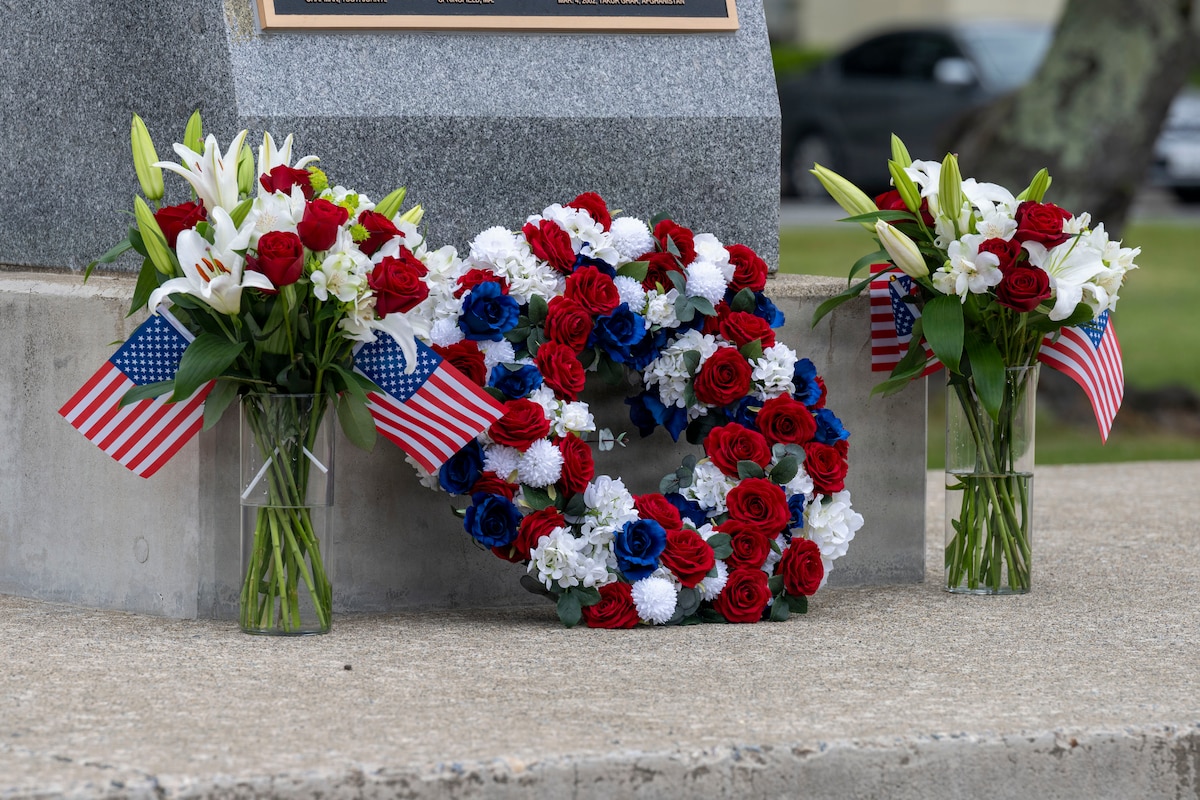 A wreath sits next to flags and flowers during a Memorial Day retreat ceremony at Misawa Air Base, Japan, May 21, 2026.