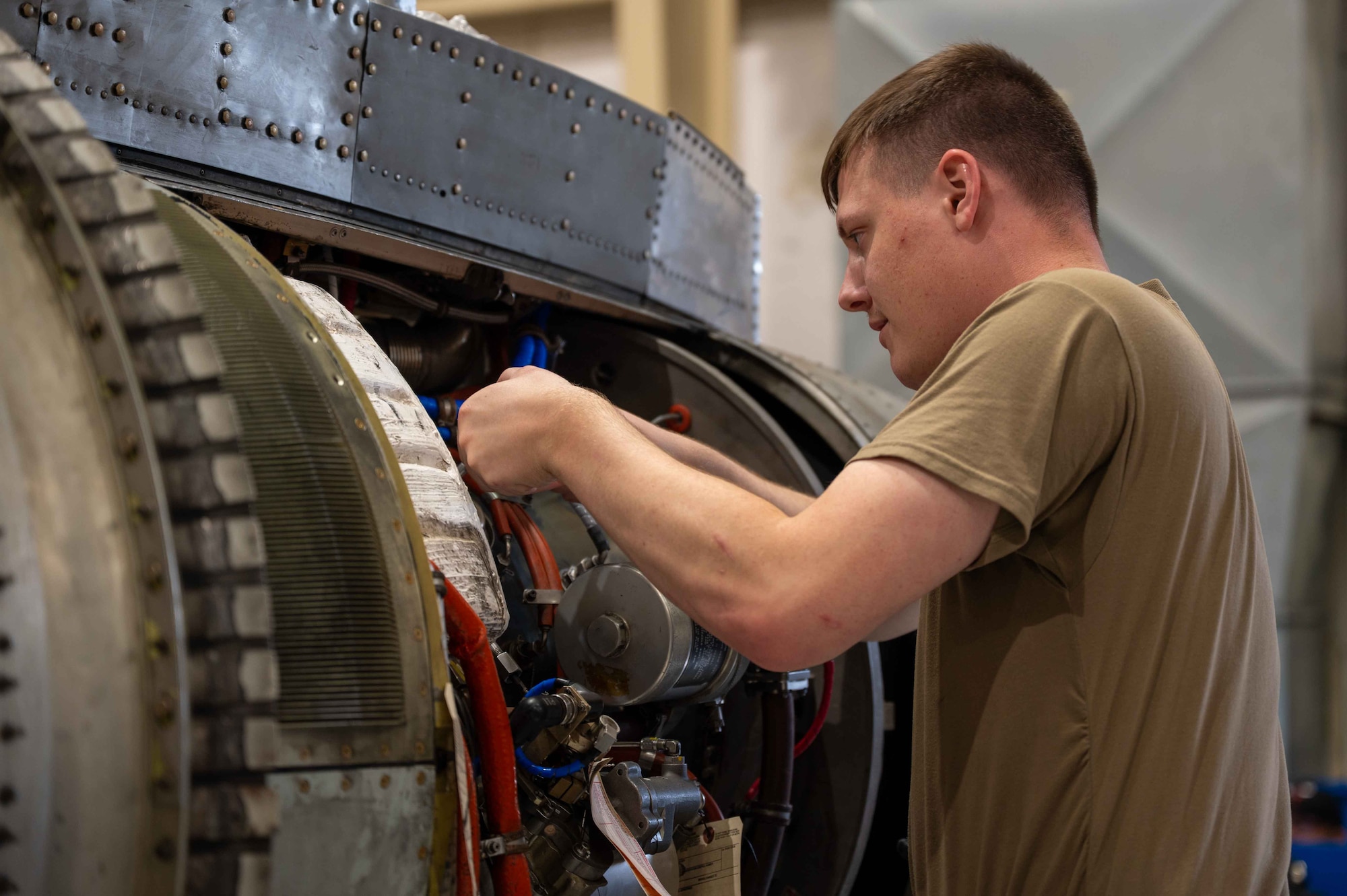 An Airman performs maintenance on a A-10 engine.