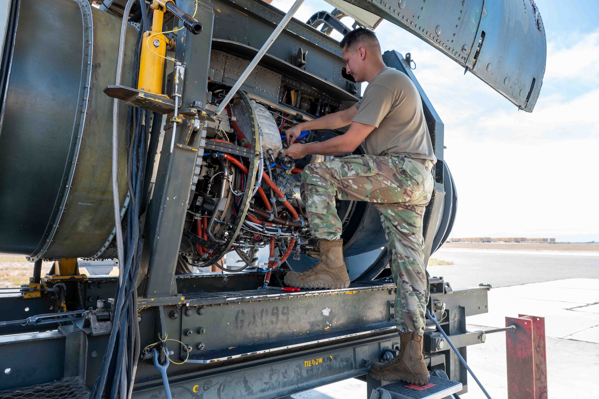 An Airman performs maintenance on a A-10 engine.