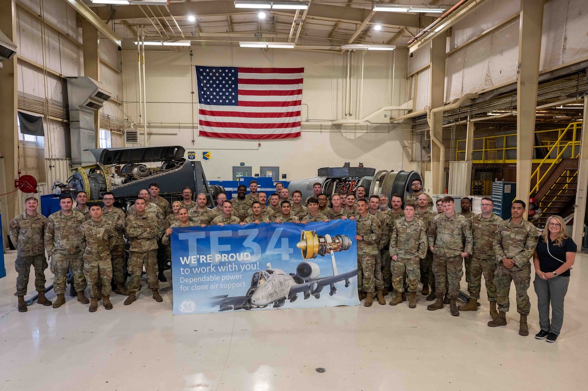 Airmen from the 355th CMS celebrate the final inspection of an A-10 engine at Davis-Monthan Air Force Base.