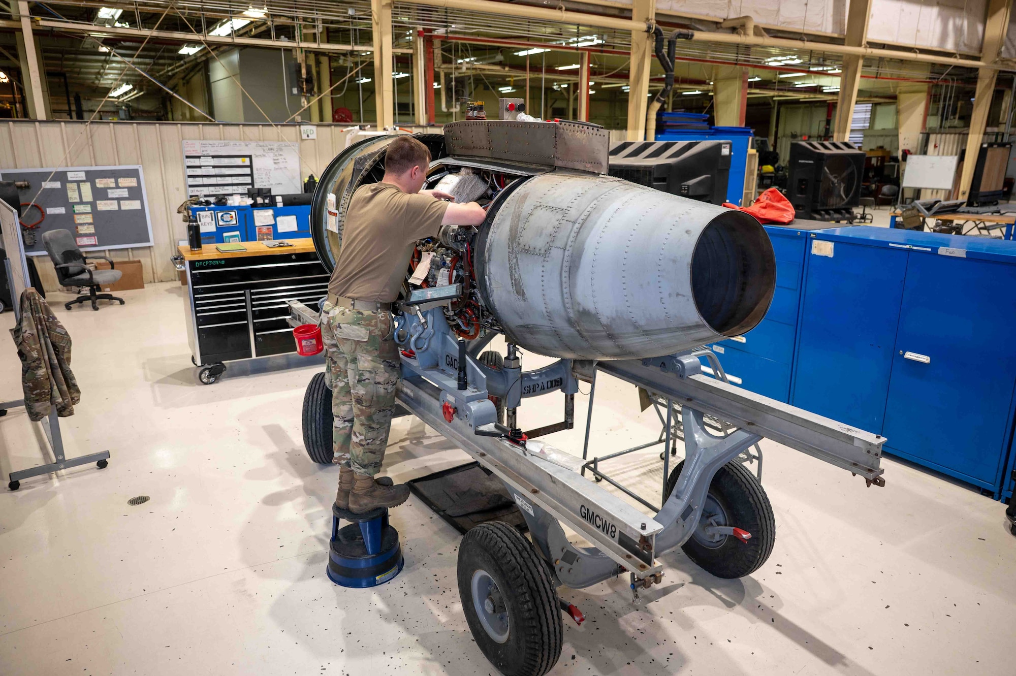 An Airman performs maintenance on a A-10 engine.
